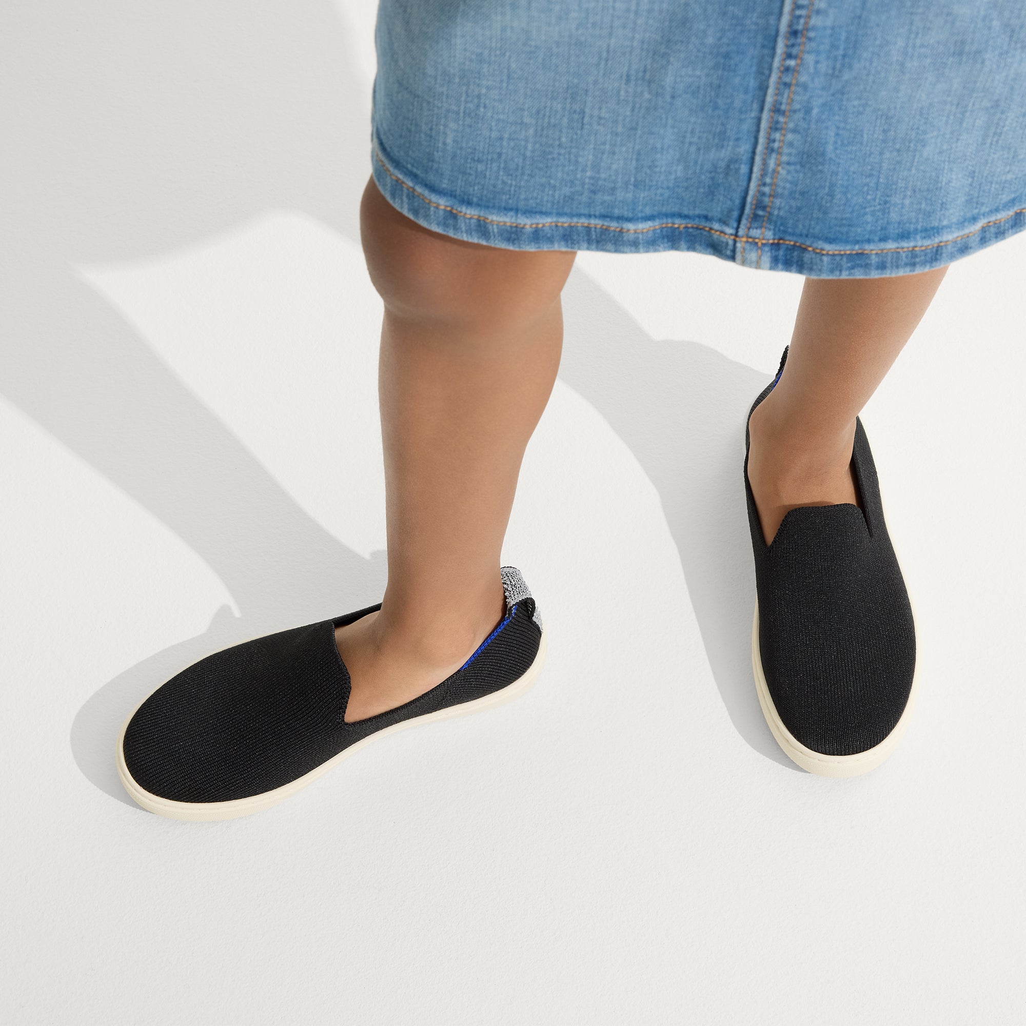 hover | Model wearing The Kids Sneaker in Black. 