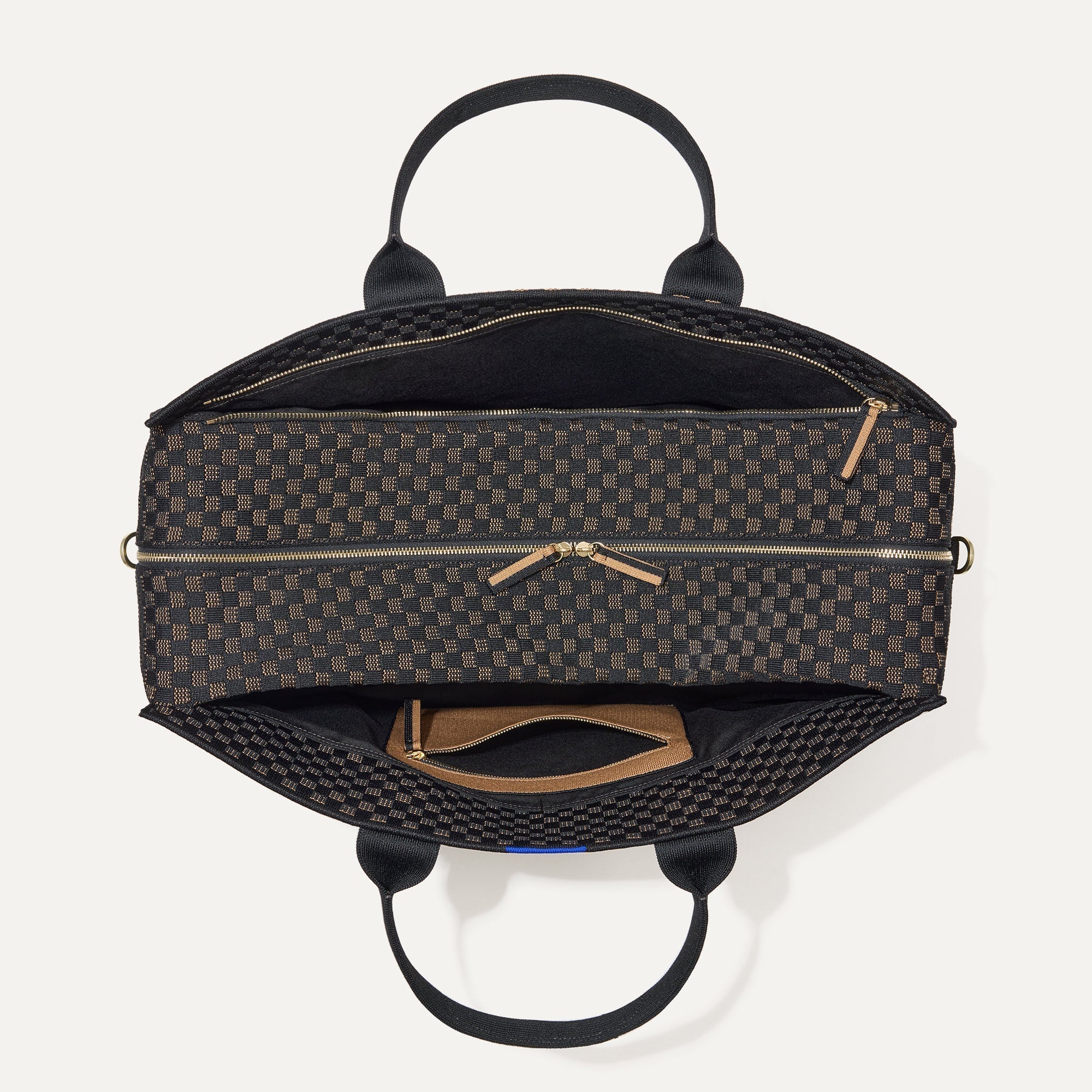 The Weekender in Night Song shown from the top with zipper side compartment and magnetic side compartment open. 