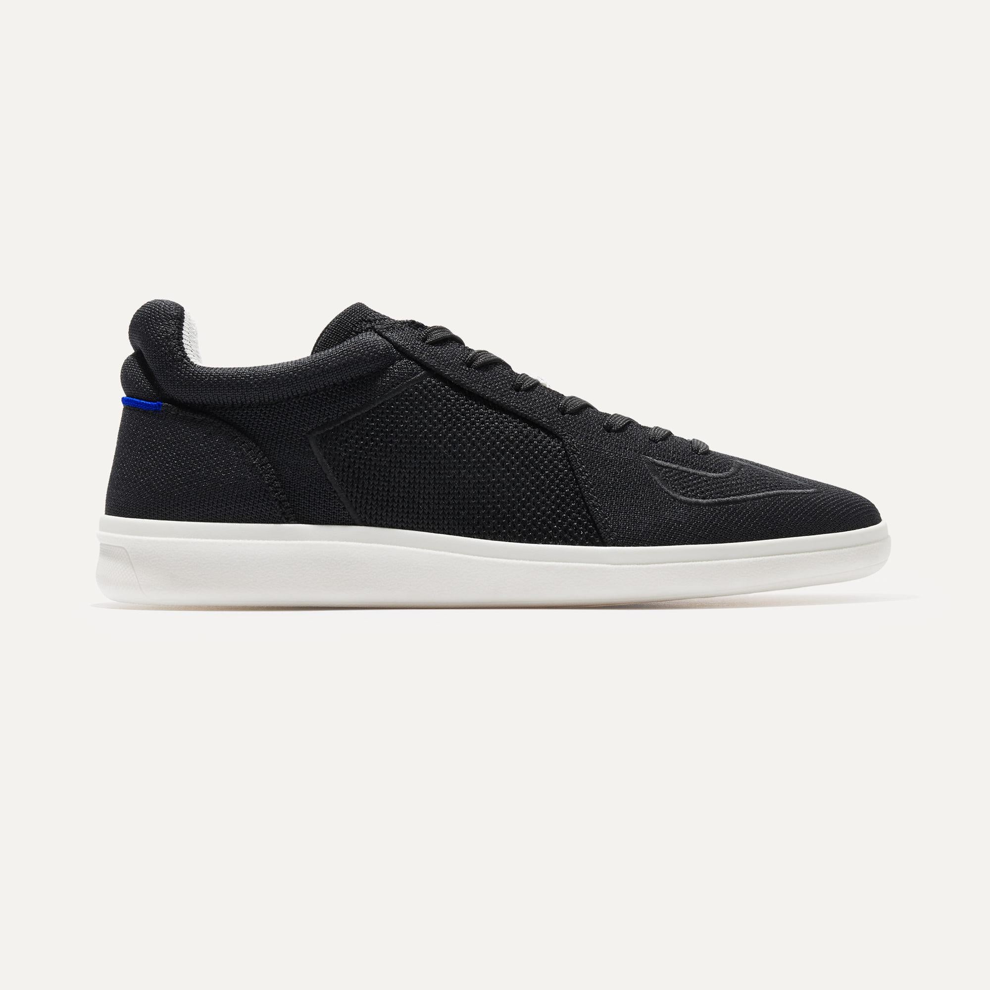 The RS01 Sneaker in Black shown from the side.