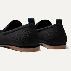 Close up of the heel of The Ravello Loafer in Stone Black, with Rothy's signature blue halo on the pull tab.
