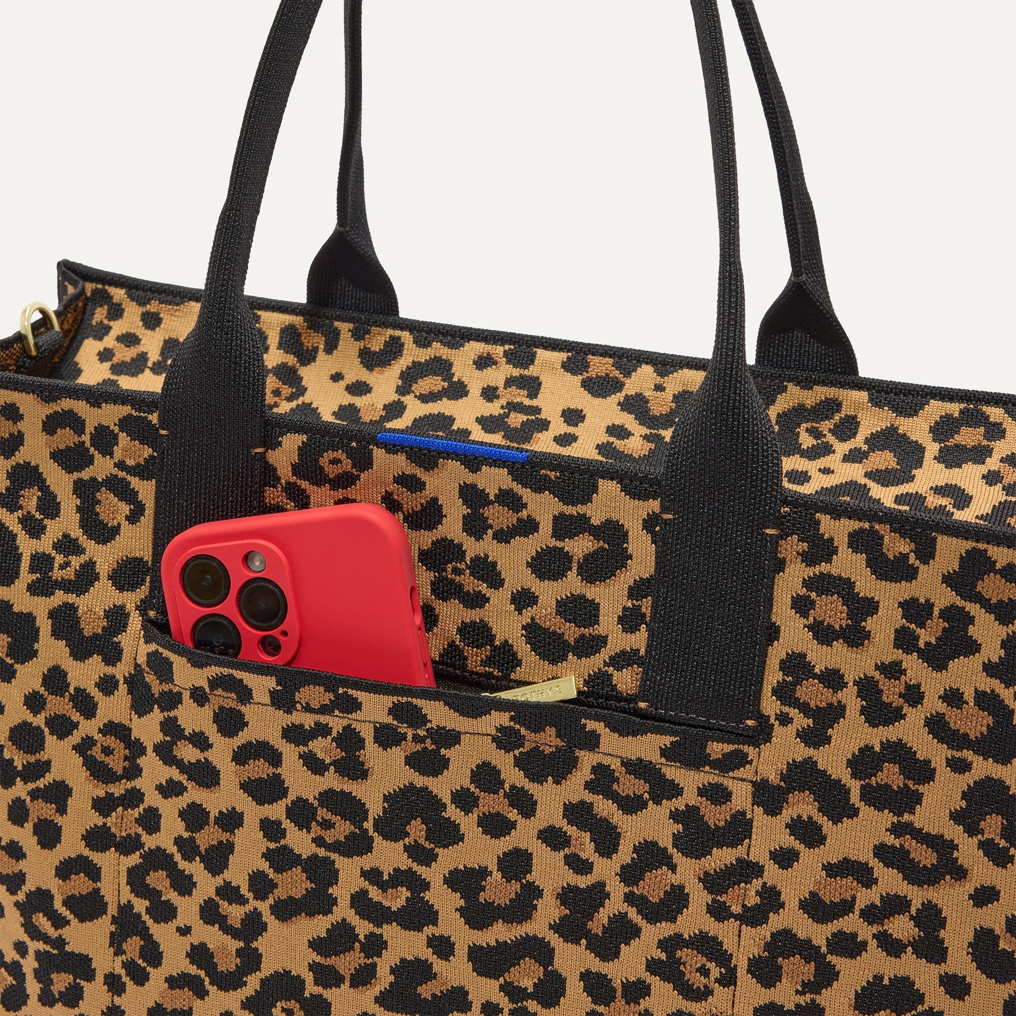 A closeup of The Classic Tote in Toasty Cat, focusing on the exterior zip pocket. 