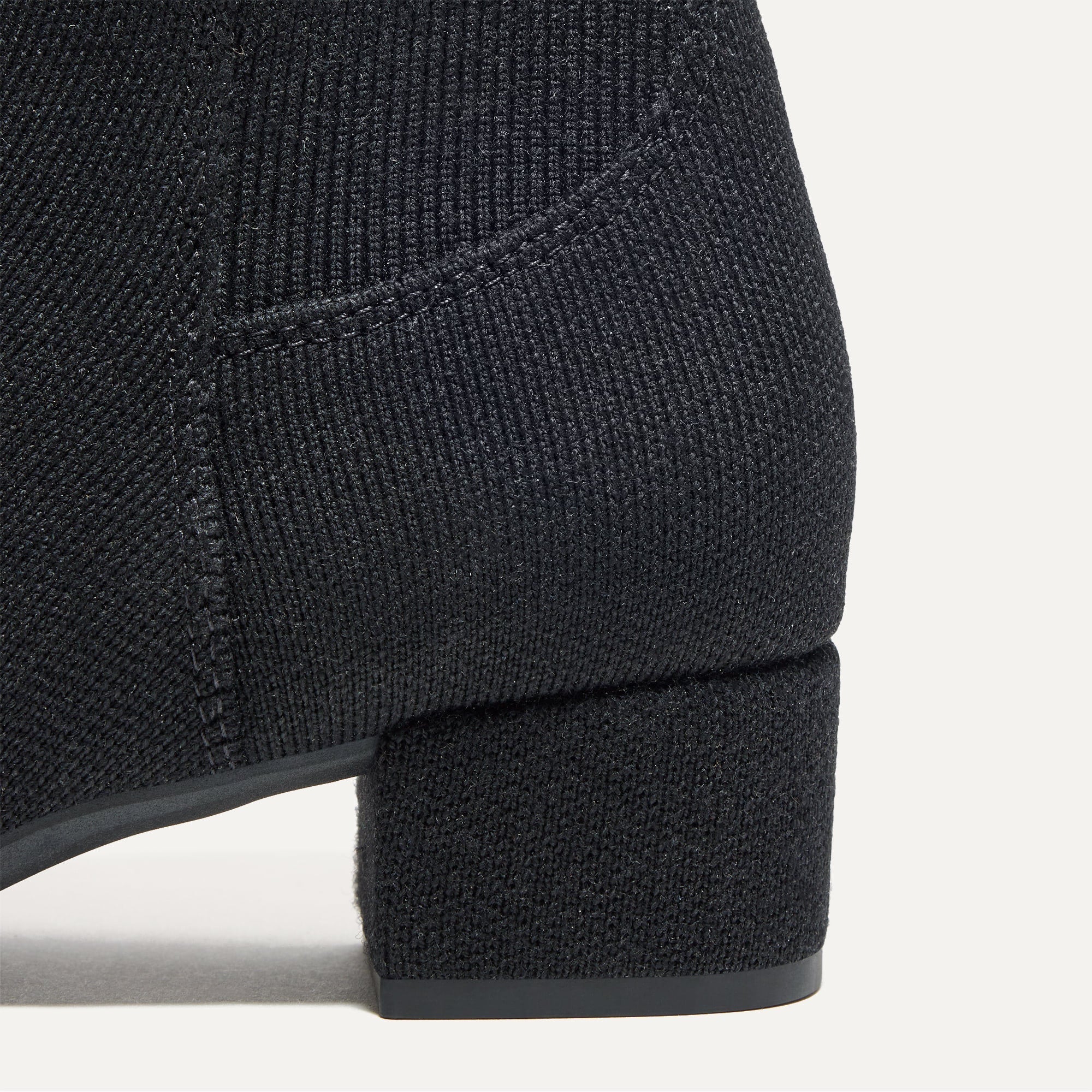 Close up of the block heel of The Classic Boot in Black.