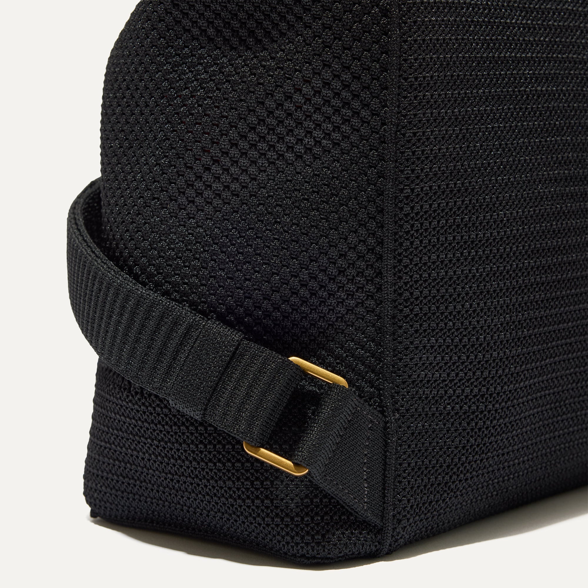 Closer look at the side straps of The Cinch Back Pack in Black.