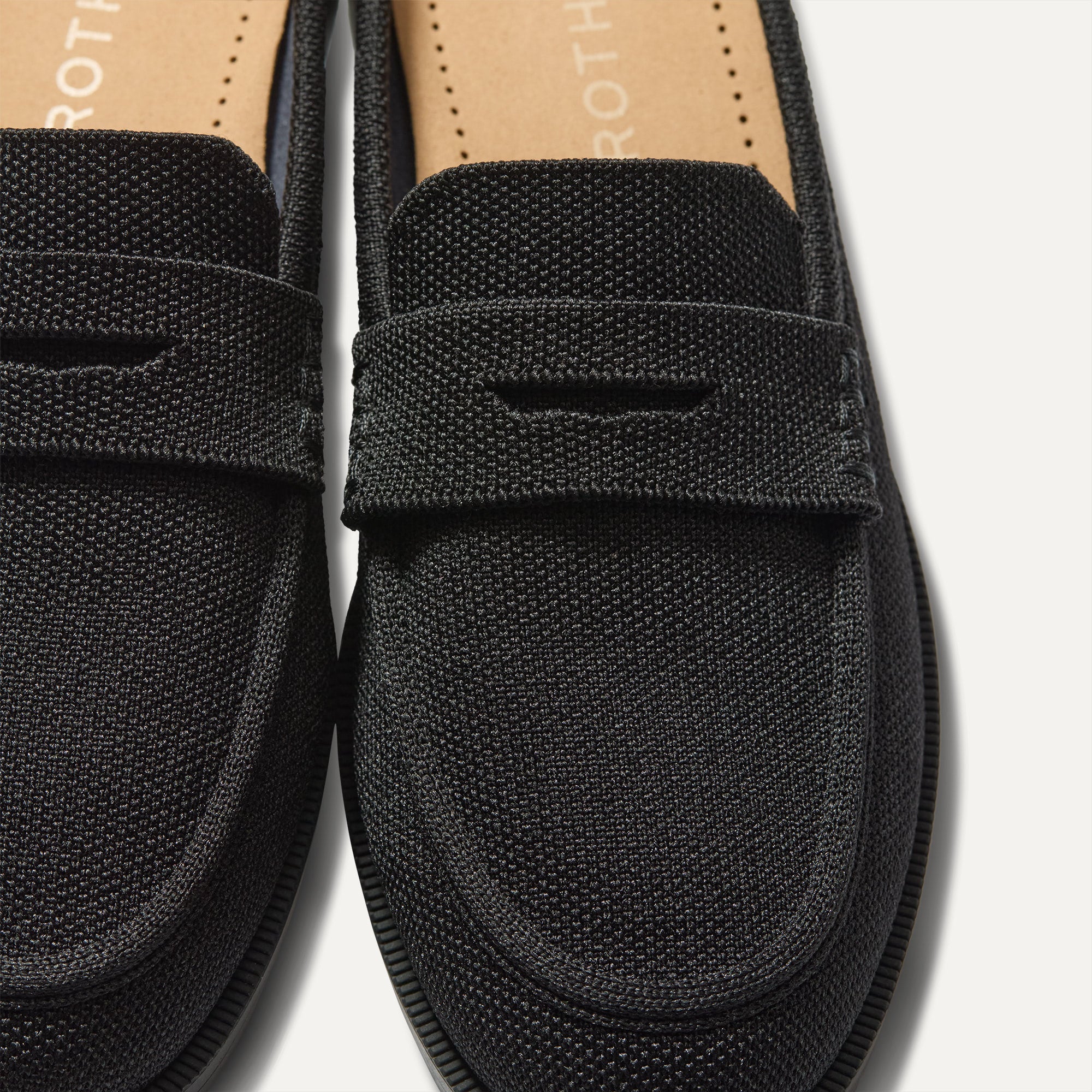 Close up of the toe and vamp of The Penny Loafer Mule in Black, showing the penny keeper detail.
