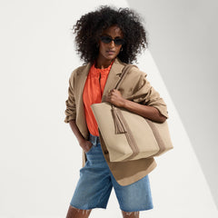 hover | Model holding The Lightweight Tote in Caramel Twist.