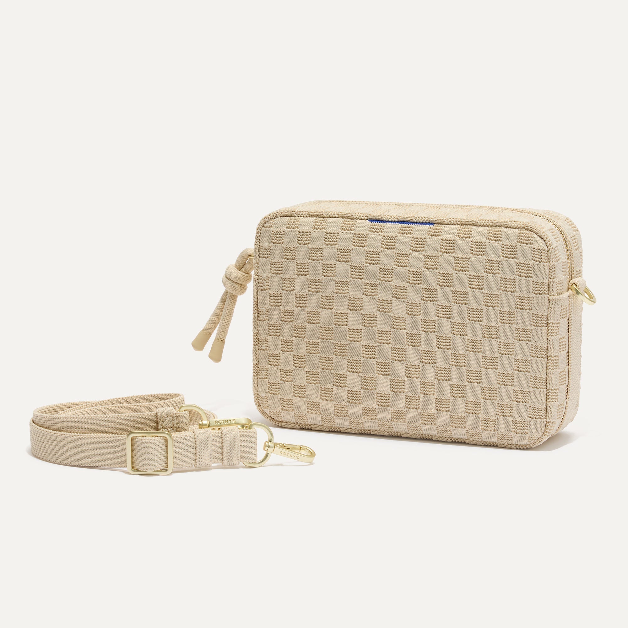 The Crossbody Camera Bag in Sesame shown by itself with removable strap. 