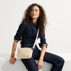 hover | The Crossbody Camera Bag in  Sesame worn as a crossbody by a model.
