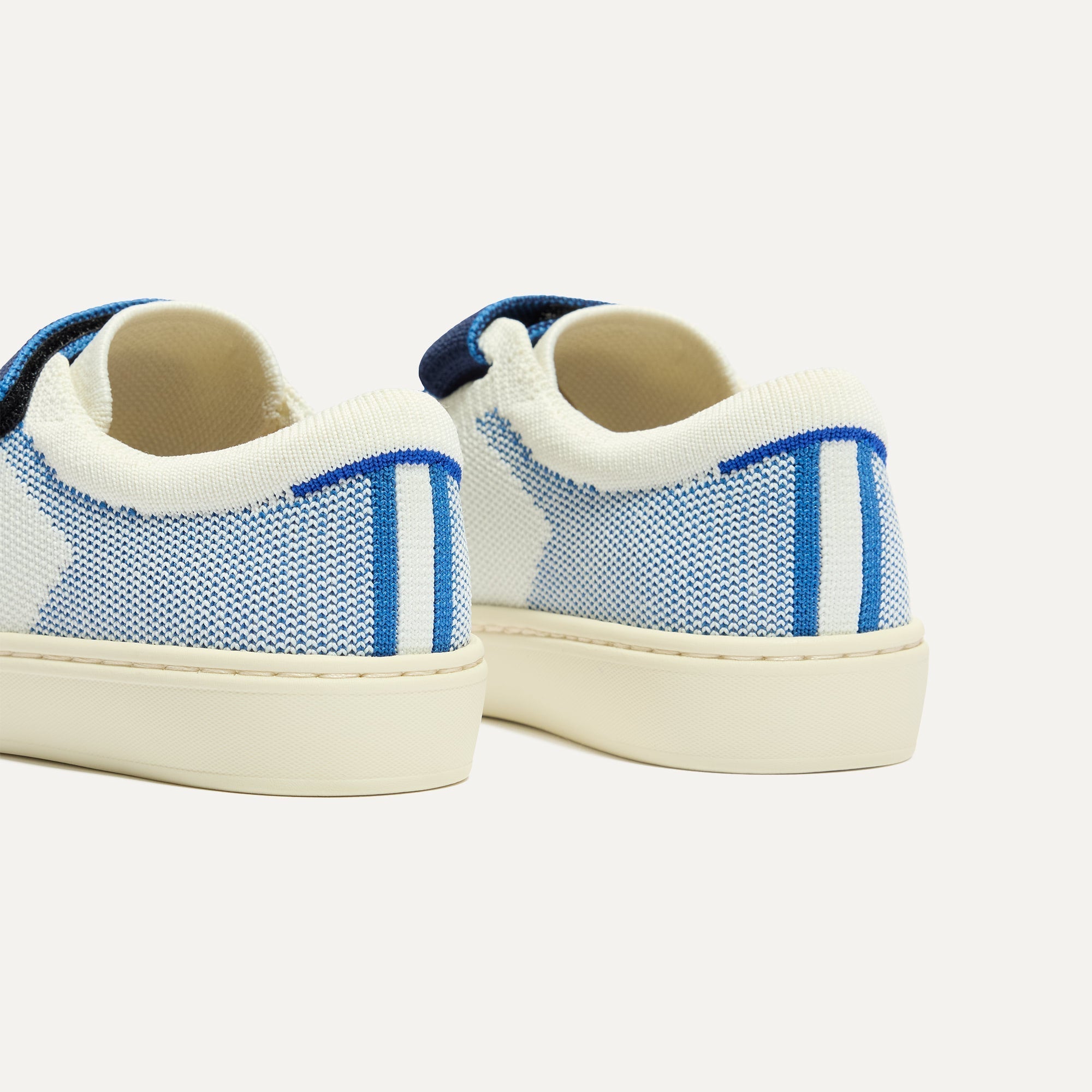 Close up of the heel of The Kids Strap Sneaker in Blue Raspberry, with Rothy's signature blue halo. 
