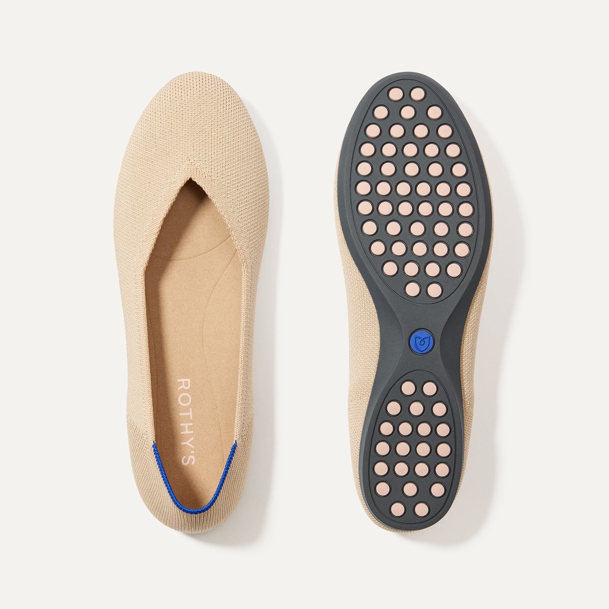 PLP |The Daily Flat in Ecru shown from the top with one shoe showing the outsole. 
