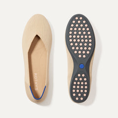 PLP |The Daily Flat in Ecru shown from the top with one shoe showing the outsole. 