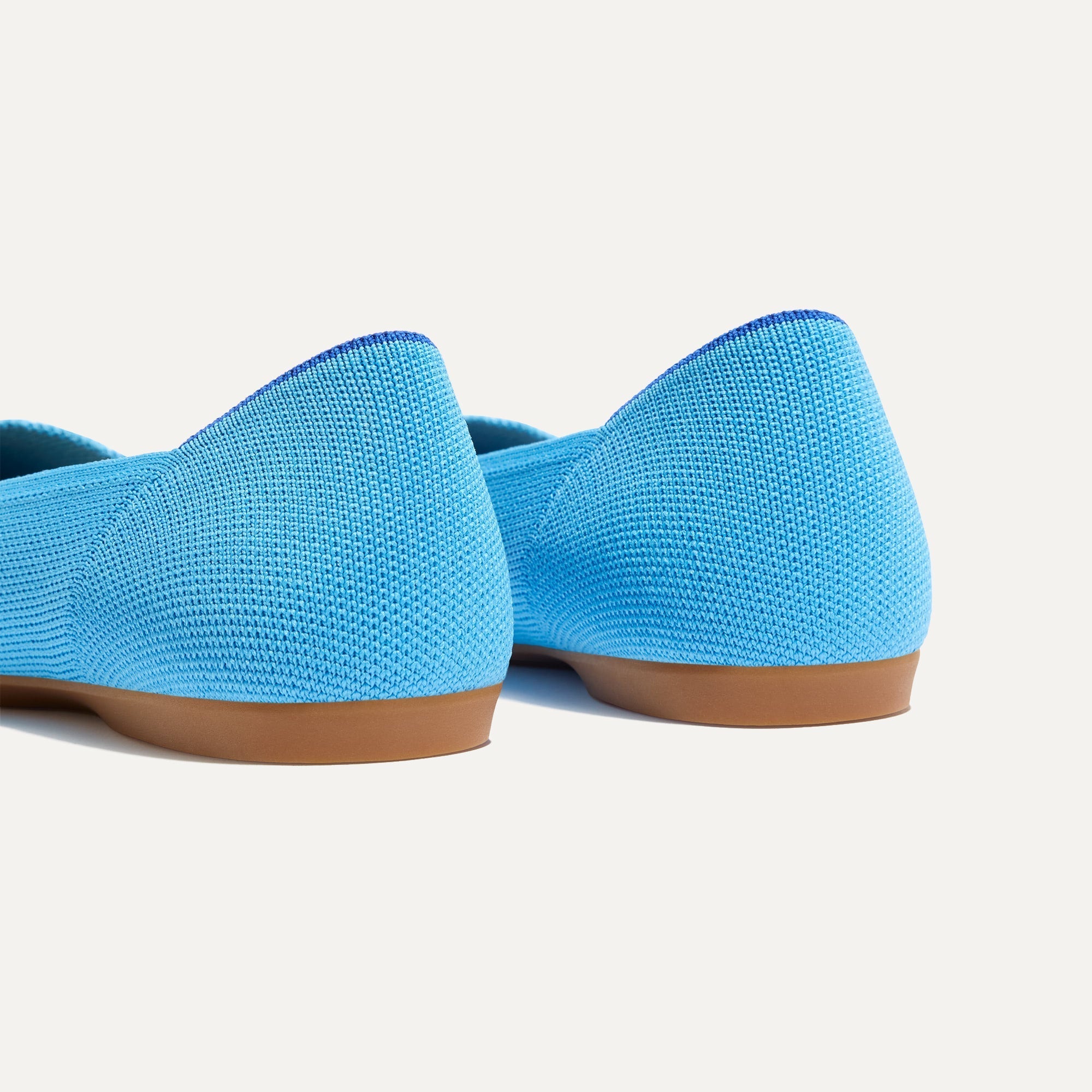 Close up of the heel of The Daily Flat in Robin Blue, with Rothy's signature blue halo. 