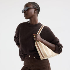 hover | Model wearing The Daily Crossbody in Oat Latte.