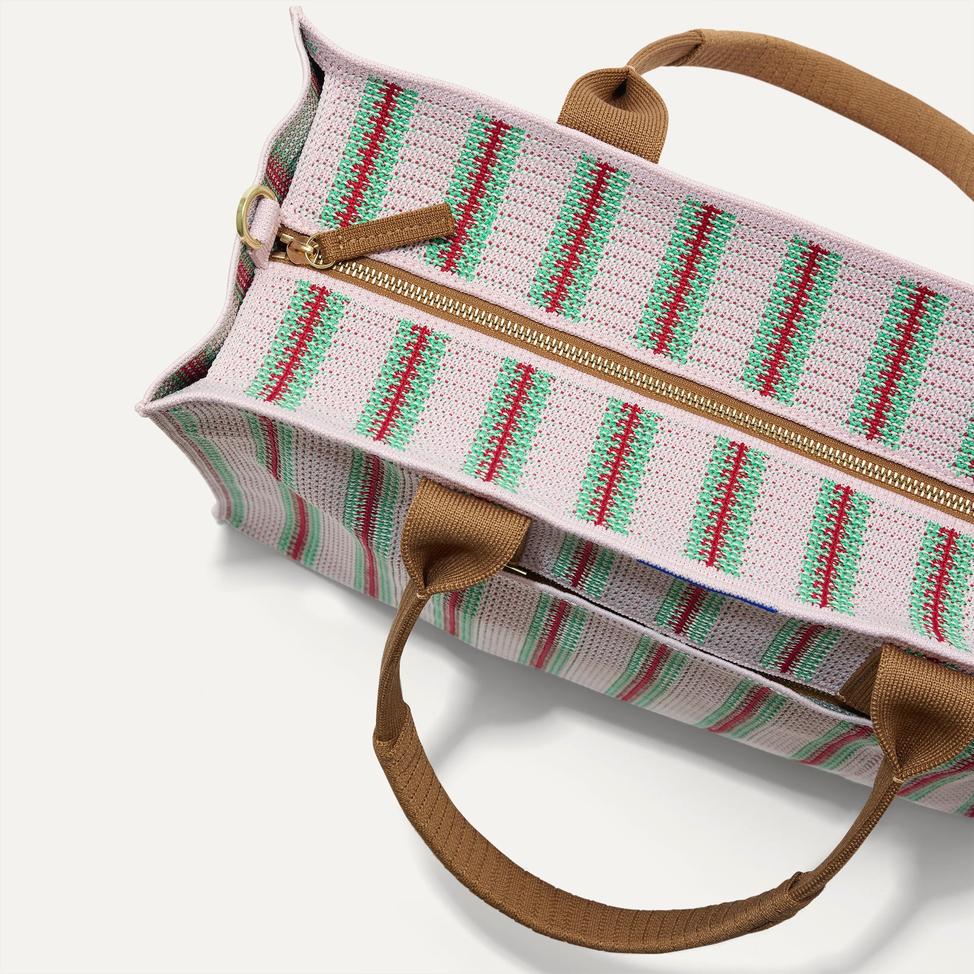 The Classic Tote in Watermelon Market Stripe, shown from above, with the top zipper closed. 