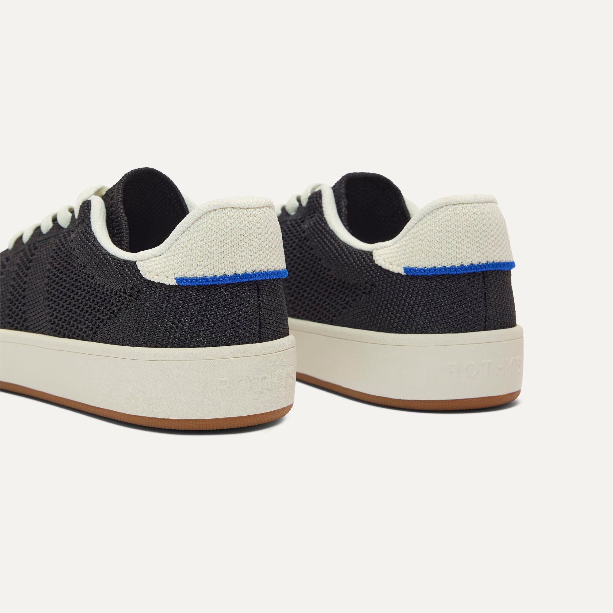 Close up of the heel of The Kids Stretch Sneaker in Zoom, with Rothy's signature blue halo. 