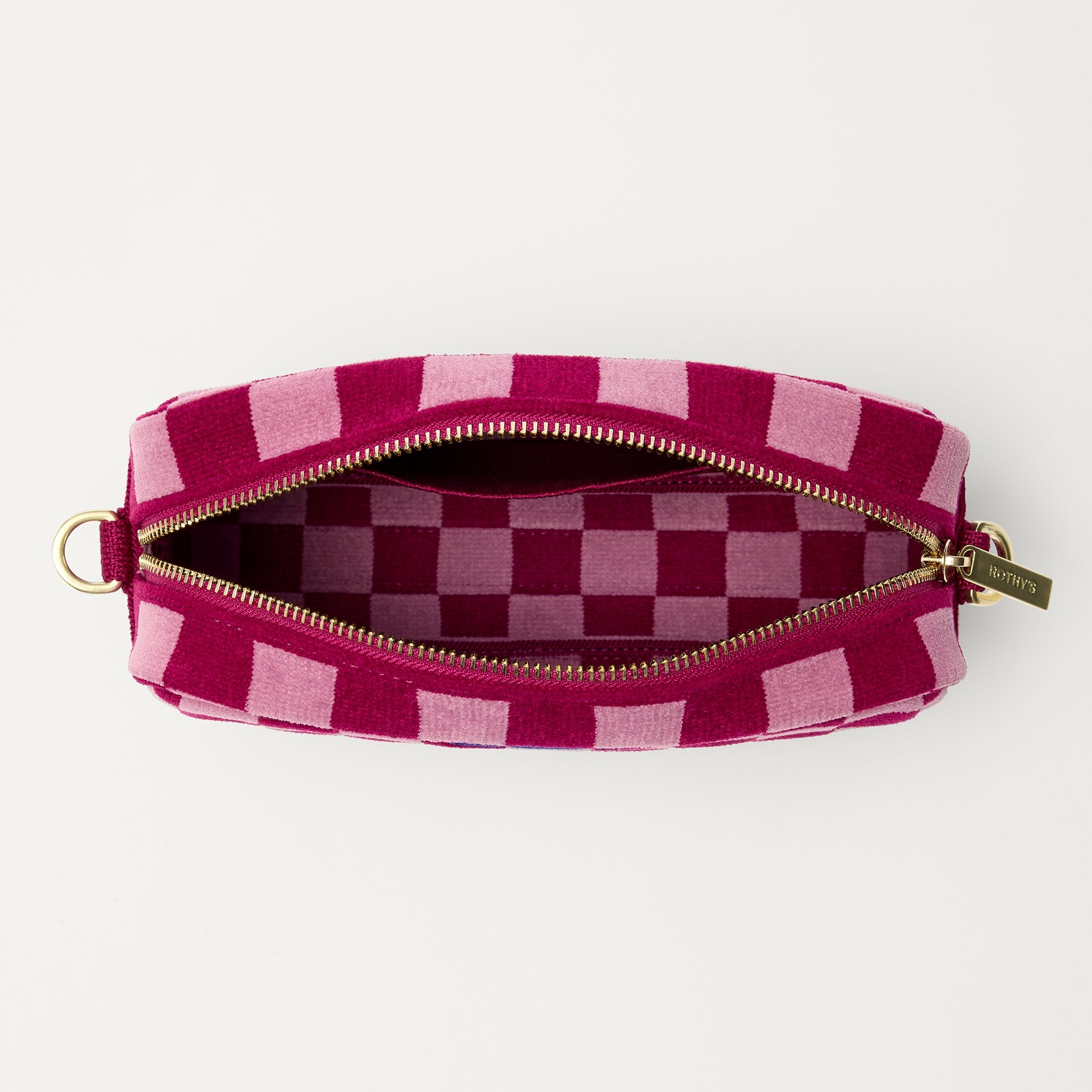 The Crossbody Camera Bag in ReVelvet™ Orchid, shown from above, with the interior exposed.
